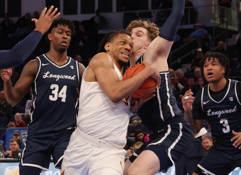 Winthrop’s Micheal Anumba heads to the basket against Longwood’s Jesper Granlund as D.A. Houston (3) and Elijah Tucker (34) watch Friday at the Big South Tournament in Greensboro, N.C.