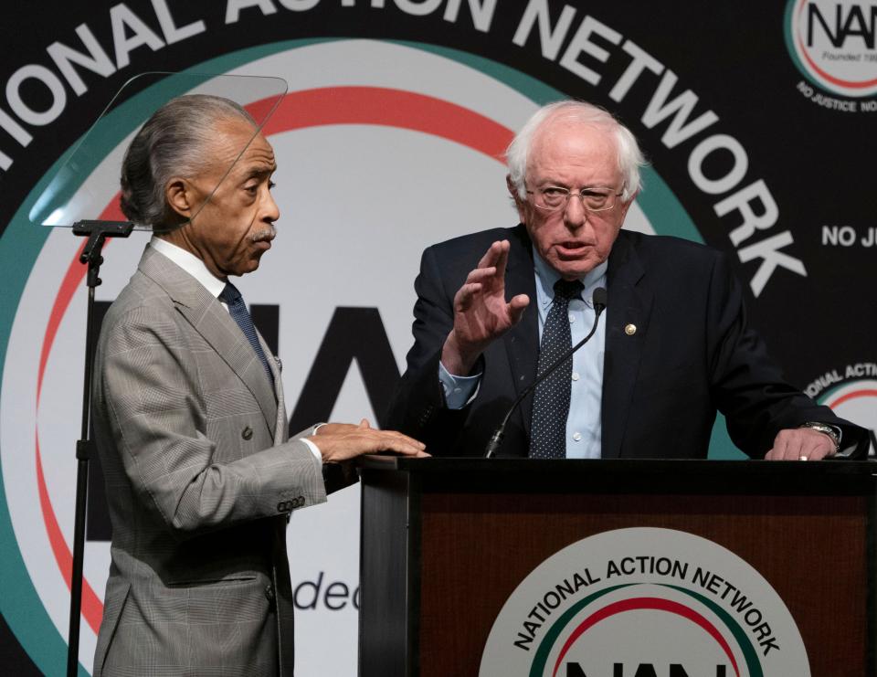 Bernie Sanders, right, speaks at a conference held by Rev. Al Sharpton in April. Sanders' critics say his efforts to focus more on race are too little, too late. (Photo: DON EMMERT/Getty Images)