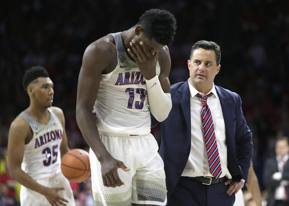 Deandre Ayton (13) and Sean Miller have had a tough couple weeks, but Arizona has thrived on the court throughout the season. (AP)