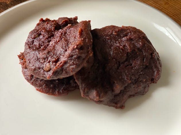 Three backed chocolate cookies on a plate