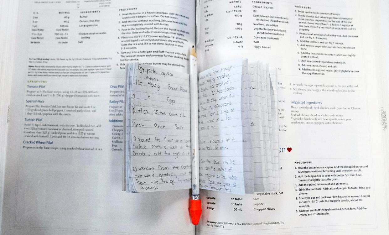 Violet Valdez’s notes rest on a cookbook during a cooking class through Sinclair Community College at the Ohio Reformatory for Women.