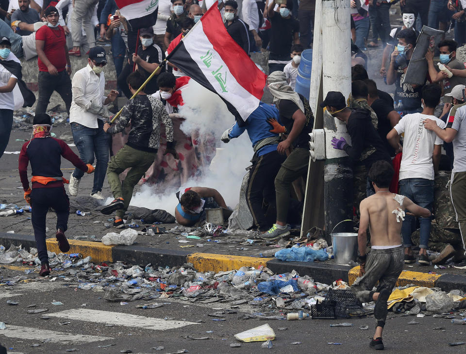 Iraq security forces fire tear gas to disperse anti-government protesters during a demonstration in Baghdad, Iraq, Monday, Oct. 28, 2019. Protests have resumed in Iraq after a wave of anti-government protests earlier this month were violently put down. (AP Photo/Hadi Mizban)