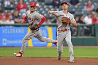 Los Angeles Angels third baseman Matt Duffy, right, throws to first base to get out Cleveland Guardians' Myles Straw during the second inning of a baseball game, Monday, Sept. 12, 2022, in Cleveland. (AP Photo/David Dermer)