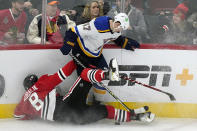 St. Louis Blues defenseman Torey Krug, top, battles for the puck against Chicago Blackhawks left wing Dominik Kubalik during the third period of an NHL hockey game in Chicago, Friday, Nov. 26, 2021. The Chicago Blackhawks won 3-2 in overtime.(AP Photo/Nam Y. Huh)