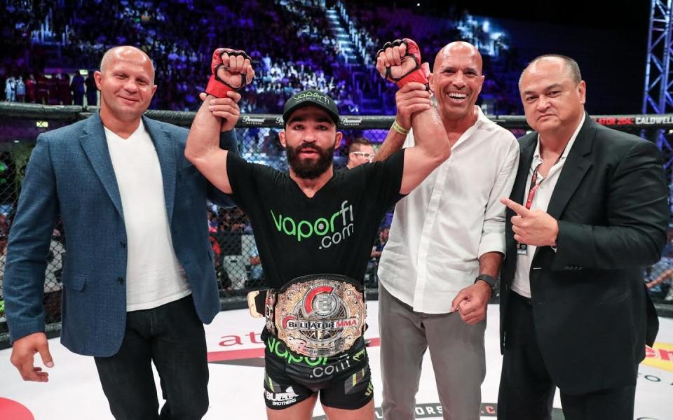 Bellator featherweight champion flanked by MMA legends Fedor Emilianenko and Royce Gracie with CEO Scott Coker    - Lucas Noonan/Bellator