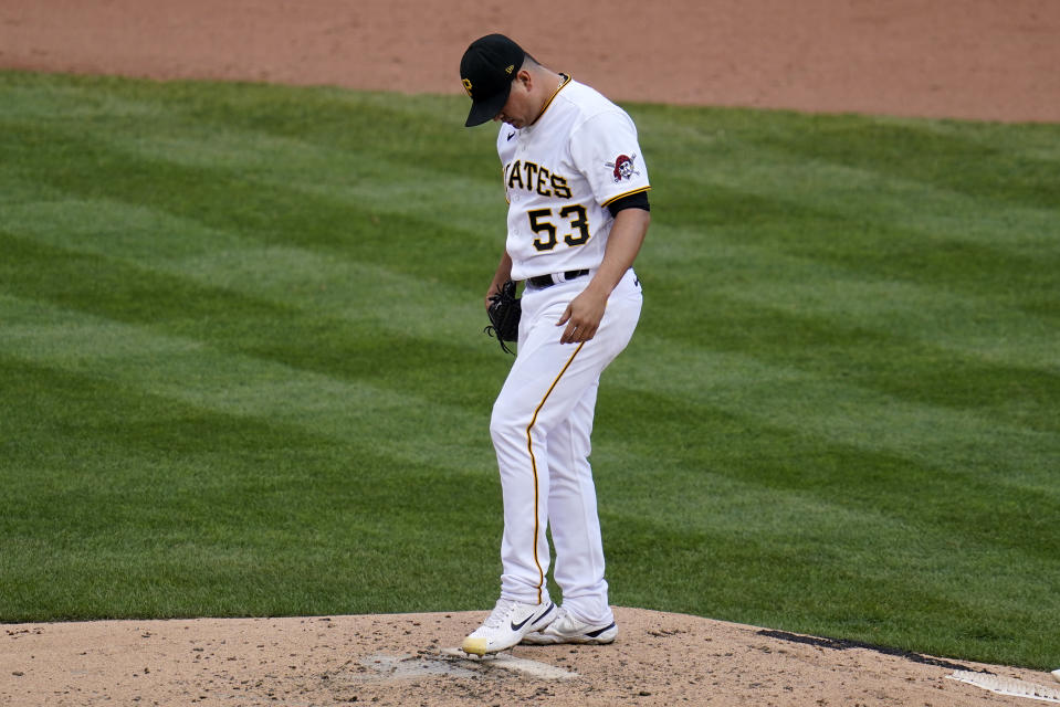 Pittsburgh Pirates relief pitcher Manny Banuelos pauses on the mound after giving up a three-run home run to Chicago Cubs' Patrick Wisdom during the fifth inning of a baseball game in Pittsburgh, Sunday, Sept. 25, 2022. (AP Photo/Gene J. Puskar)
