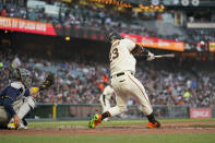 San Francisco Giants' Joc Pederson hits an RBI single against the Milwaukee Brewers during the third inning of a baseball game in San Francisco, Thursday, July 14, 2022. (AP Photo/Godofredo A. Vásquez)