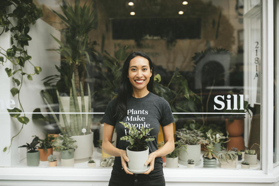 In this 2019 photo provided by The Sill shows Eliza Blank from The Sill holding a Rattlesnake Calathea outside the shop in San Francisco, Calif. Blank is the founder and CEO of the popular gardening store and a plant influencer on Instagram. (Kelly Boitano/The Sill via AP)