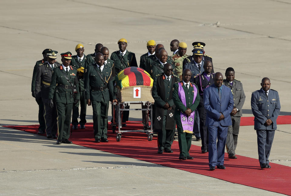 A coffin carrying the remains of Zimbabwe's longtime ruler Robert Mugabe arrives from Singapore, at Robert Gabriel Mugabe International Airport in Harare, Zimbabwe, Wednesday, Sept. 11, 2019. The body of Mugabe is being flown to the capital, Harare, on Wednesday where it will be displayed at historic locations for several days before burial at a location still undecided because of friction between the ex-leader's family and the government. AP Photo/Themba Hadebe)