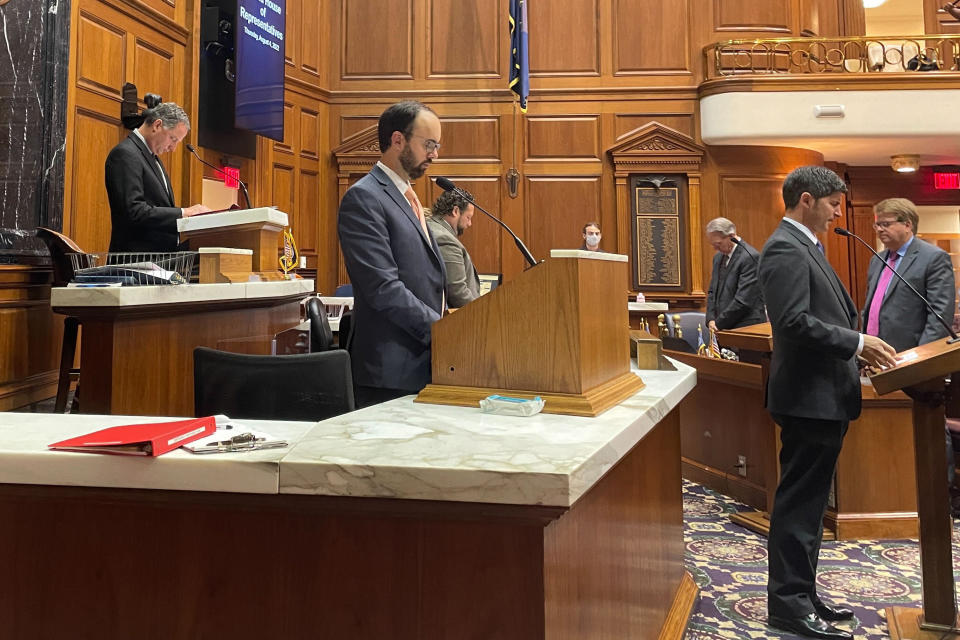 Indiana GOP House Speaker Todd Huston, back left, bows his head while Republican Rep. Timothy Wesco, far right, honors Republican U.S. Rep. Jackie Walorski, Thursday, Aug. 4, 2022, in Indianapolis. Walorski died Wednesday, Aug. 3, in a car crash in her northern Indiana district. Wesco now represents the district Walorski served during her six years in the state's Legislature. (AP Photo/Arleigh Rodgers)