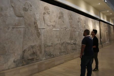 Visitors look at Assyrian mural sculptures from Khorsabad, at the Iraqi National Museum in Baghdad March 8, 2015. REUTERS/Khalid al-Mousily