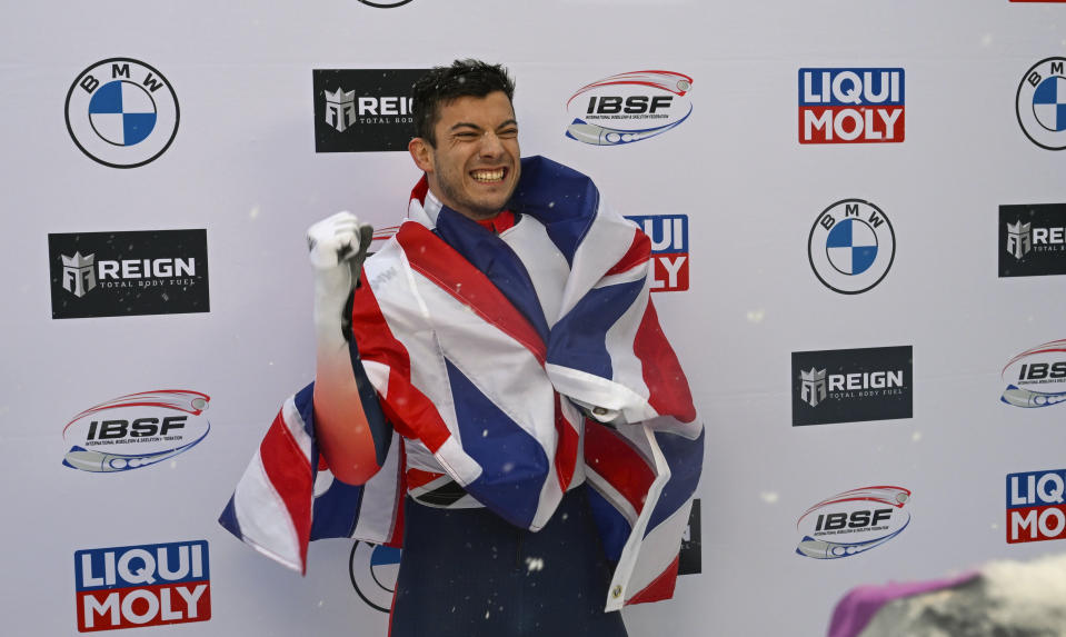 Matt Weston, of Britain, celebrates winning the men's skeleton World Cup race on Friday, Dec. 16, 2022, in Lake Placid, N.Y. (AP Photo/Hans Pennink)