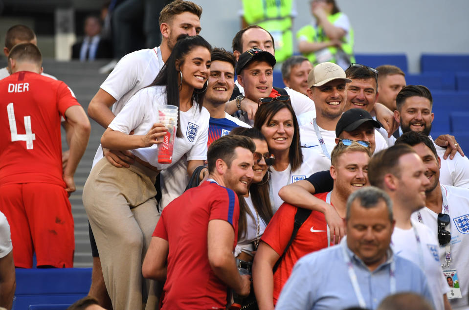 Harry Maguire poses with his friend and family after England beat Sweden