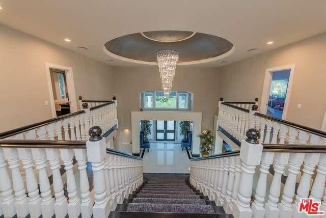 <p>As you enter the mansion you are greeted by a dramatic grand stairway. <br> (Realtor.com) </p>