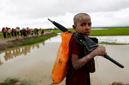 A Rohingya refugee boy reacts to the camera as he walks after travelling over the Bangladesh-Myanmar border in Teknaf, Bangladesh, September 1, 2017. REUTERS/Mohammad Ponir Hossain