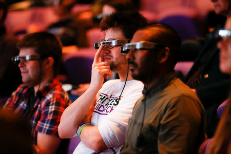 People watch a live performance of Exit the King at the National Theatre while wearing Smart Caption Glasses, designed by Epson, in London, Britain, October 3, 2018. REUTERS/Henry Nicholls