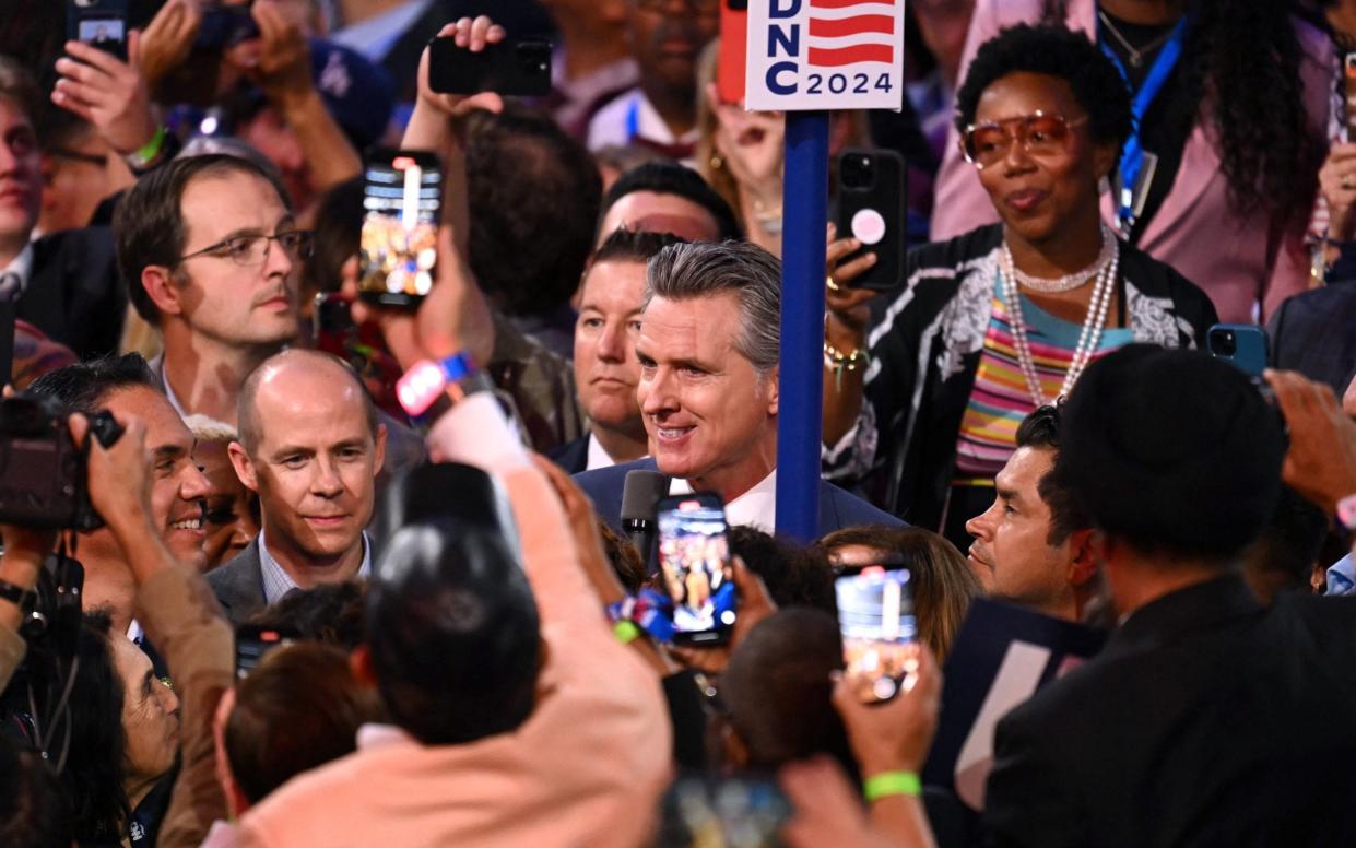 Gavin Newsom speaks alongside California delegation as they cast their vote during the ceremonial roll call vote on the second day of the DNC