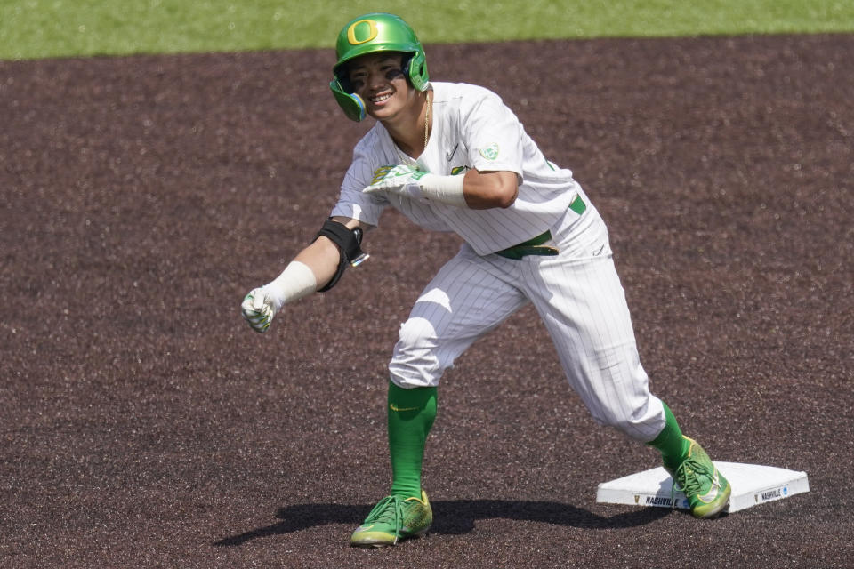 Oregon right fielder Rikuu Nishida celebrates his double against Xavier as he stands on second base during the seventh inning of an NCAA college baseball tournament regional game Friday, June 2, 2023, in Nashville, Tenn. Oregon won 5-4. (AP Photo/George Walker IV)