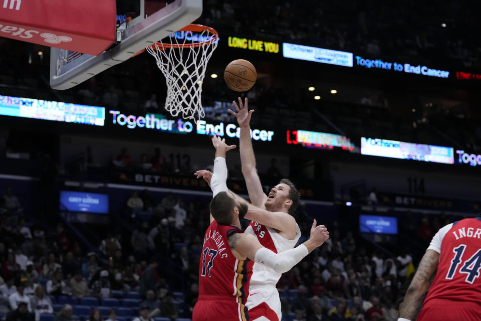 Toronto Raptors center Jakob Poeltl shoots against New Orleans Pelicans center Jonas Valanciunas (17) in the first half of an NBA basketball game in New Orleans, Monday, Feb. 5, 2024. (AP Photo/Gerald Herbert)