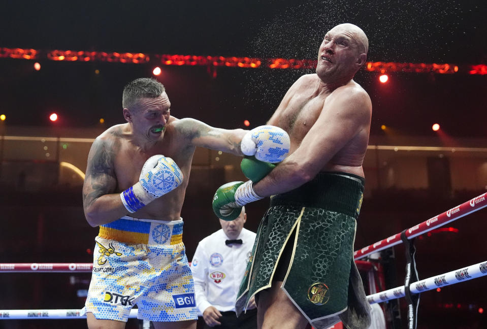 Britain’s Tyson Fury, right, takes a blow from Ukraine’s Oleksandr Usyk during their undisputed heavyweight world championship boxing fight at the Kingdom Arena in Riyadh, Saudi Arabia, Sunday, May 19, 2024. (Nick Potts/PA via AP)