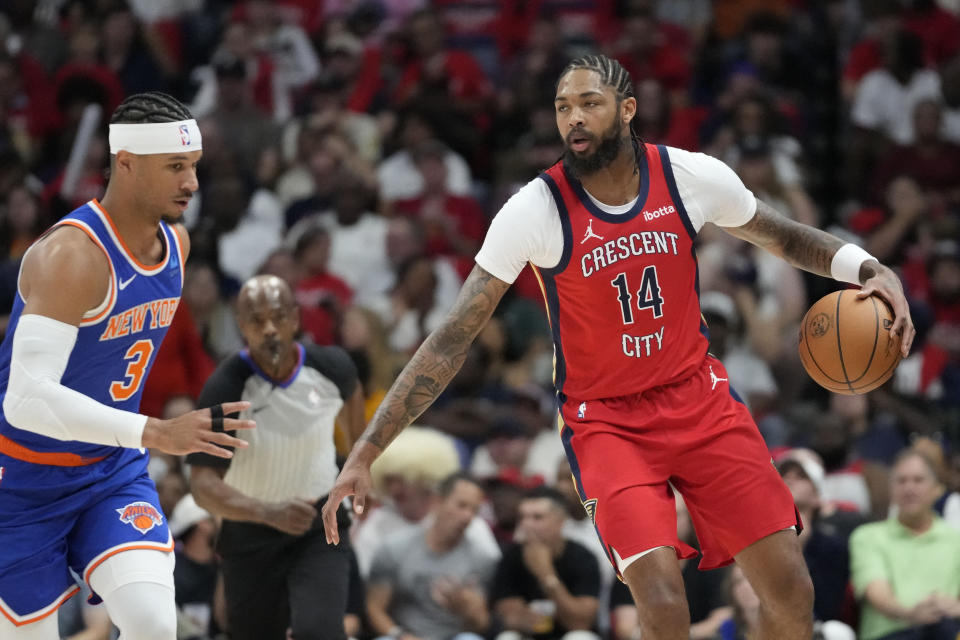 New Orleans Pelicans forward Brandon Ingram (14) moves the ball down court against New York Knicks guard Josh Hart (3) in the first half of an NBA basketball game in New Orleans, Saturday, Oct. 28, 2023. (AP Photo/Gerald Herbert)