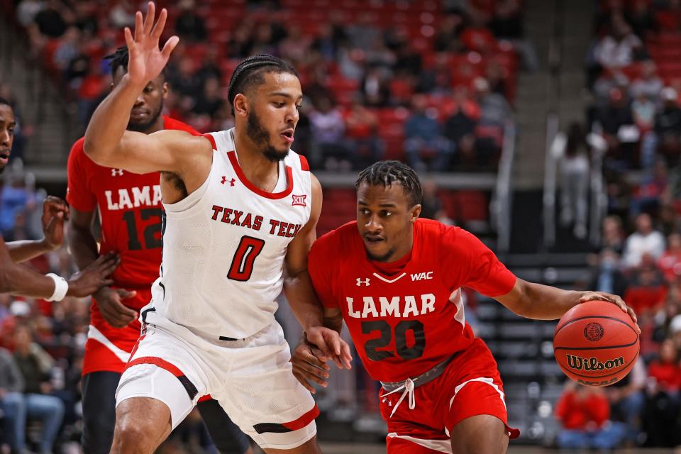 Lamar's C.J. Roberts (20) drives the ball around Texas Tech's Kevin Obanor (0) during the second half of an NCAA college basketball game on Saturday, Nov. 27, 2021, in Lubbock, Texas.
