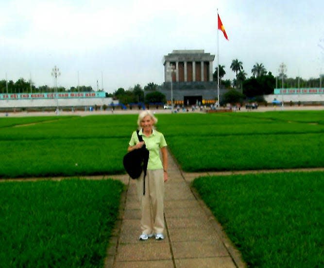 Roxana Seely stands in front of the Ho Chi Ming Presidential Palace in Vietnam.