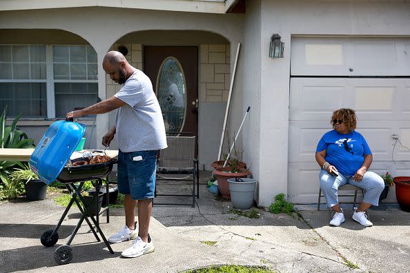 FORT MYERS FLORIDA - SEPTEMBER 29:  (L-R) Brock Hall and Brenda Hall cook lunch on their barbeque as Hurricane Ian passed through on September 29, 2022 in Fort Myers, Florida. The hurricane brought high winds, storm surge and rain to the area causing severe damage. (Photo by Joe Raedle/Getty Images)