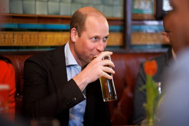 PHOTO: Britain's Prince William drinks a pint of cider, as he and Kate, Princess of Wales visit the Dog & Duck pub in London, May 4, 2023. (Jamie Lorriman/AP)
