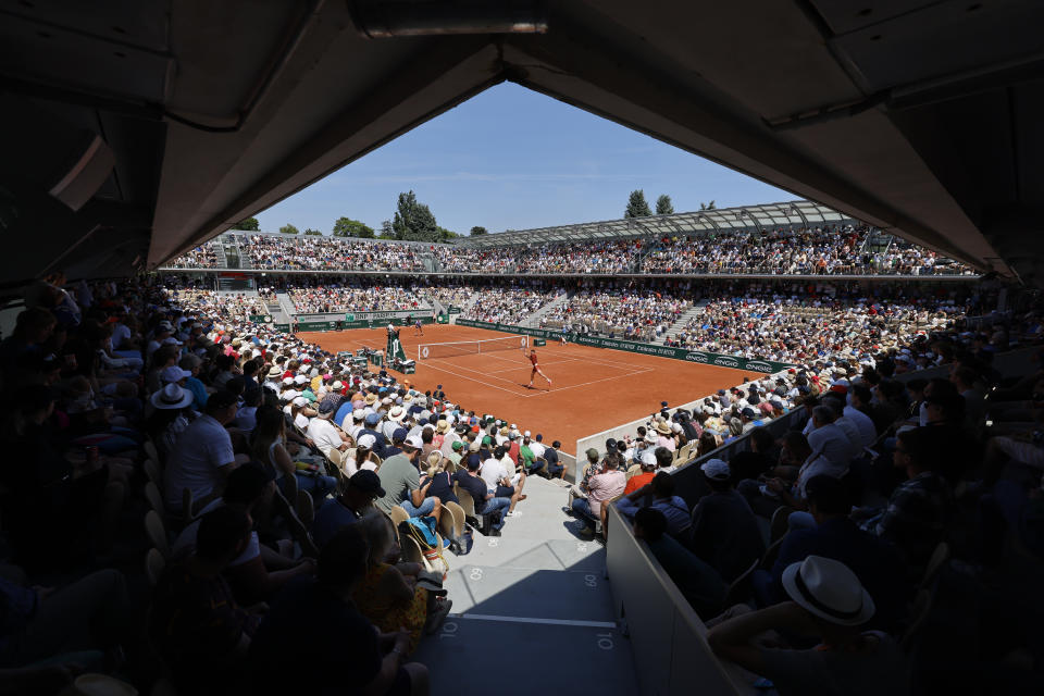 Australia's Thanasi Kokkinakis, front, plays a shot against Switzerland's Stan Wawrinka, rear, during their second round match of the French Open tennis tournament at the Roland Garros stadium in Paris, Wednesday, May 31, 2023. (AP Photo/Jean-Francois Badias)