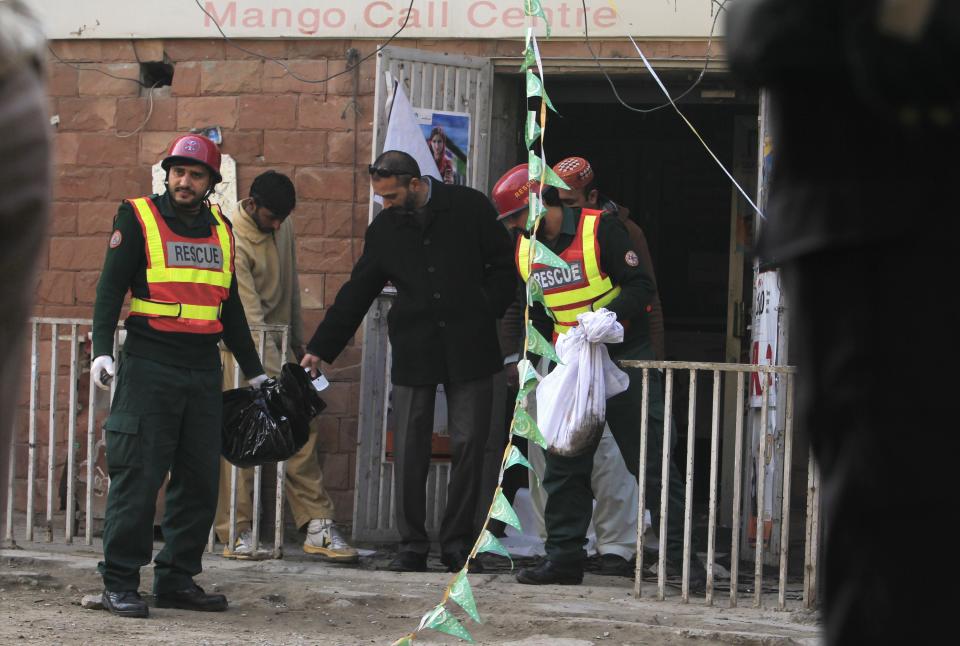Rescue workers collect evidence from the site of a suicide blast in Rawalpini