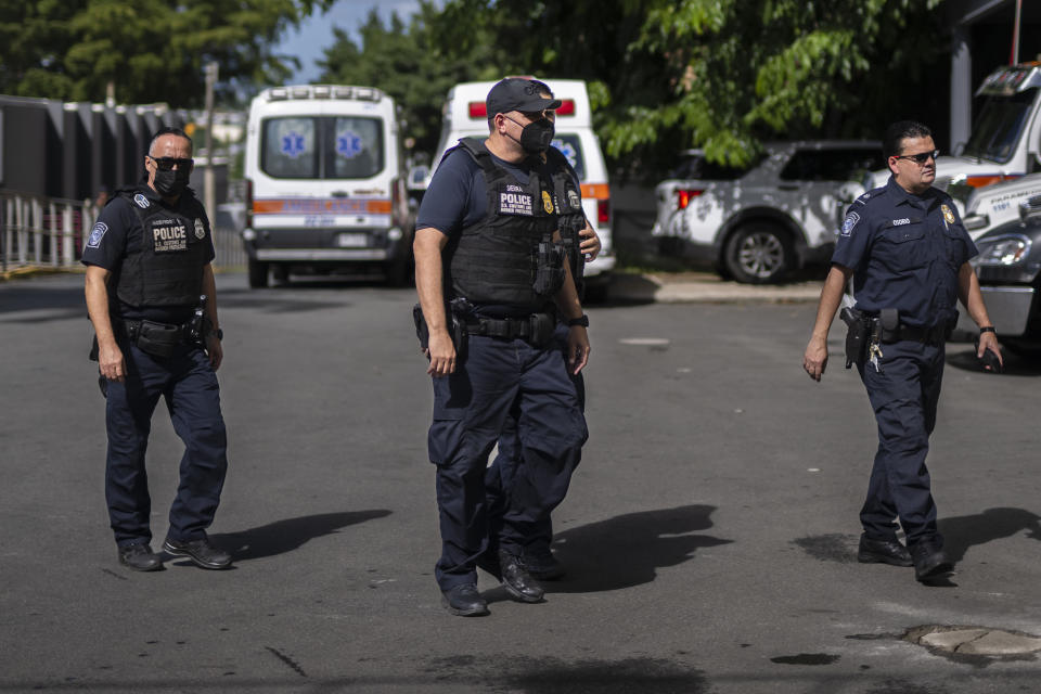 Federal agents wait for news of their injured colleagues outside the Rio Piedras Medical Center in San Juan, Puerto Rico, Thursday, Nov. 17, 2022, who were airlifted from the coast of Cabo Rojo, a major drug smuggling corridor for cocaine coming out of South America known as the Mona Passage. A U.S. Customs and Border Protection agent and a suspected smuggler died during a shootout Thursday off the Puerto Rican coast, authorities said. (Courtesy of Carlos Giusti/GFR MEDIA via AP)