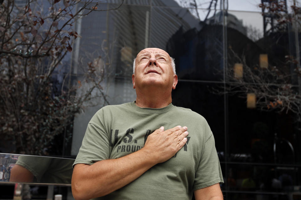 United States Navy veteran Richard Fill, of Easton, Penn., looks up at 1 World Trade Center during a moment of silence on the 13th anniversary of the Sept. 11, 2001 attacks, Thursday, Sept. 11, 2014, in New York. (AP Photo/Jason DeCrow)