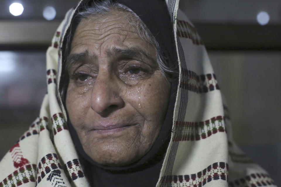 Indian passenger Abida Bano cries as she arrives at Lahore railway station to travel to India, in Lahore, Pakistan, Thursday, Feb. 28, 2019. The Pakistan government temporally suspended the operation of the Samjhuta Express that runs from Lahore to New Delhi, India, after escalation of tensions between the nuclear-armed rivals. (AP Photo/K.M. Chaudary)