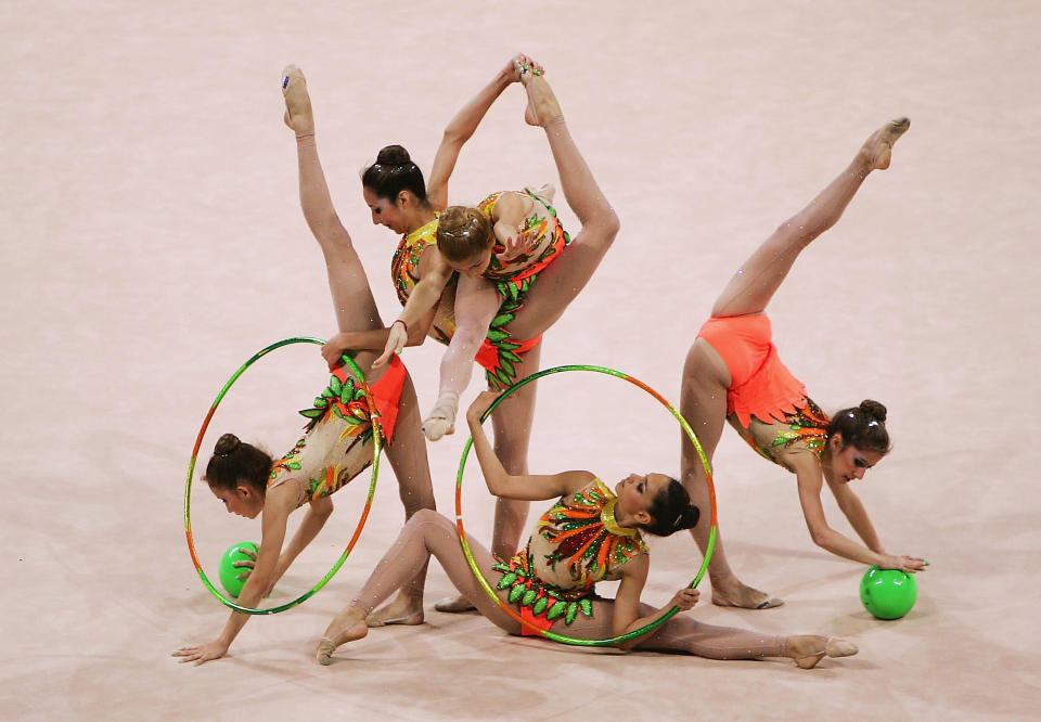 ATHENS - AUGUST 26: Brazil dances in the rhythmic gymnastics group qualifications on August 26, 2004 during the Athens 2004 Summer Olympic Games at the Galatsi Olympic Hall in Athens, Greece. (Photo by Mike Hewitt/Getty Images)