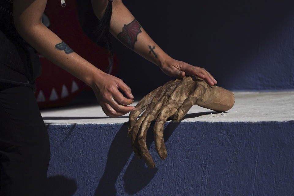 Artisan Ana Lilia Neri works on a cardboard hand depicting a devil-like figure popularly known as “Judas,” at the Santa Maria La Ribera Cultural Center in Mexico City, Wednesday, April 5, 2023. Every Holy Saturday Mexicans get ready for the traditional "burning of Judas". During this popular activity on the sidelines of the Holy Week celebrations of the Catholic Church, people gather in neighborhoods across the country to burn cardboard figures of Judas that represent evil. (AP Photo/Marco Ugarte)