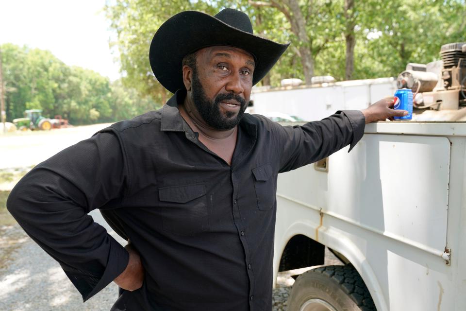 John Boyd takes a break from baling hay at his farm in Boydton, Va., on May 27. Boyd says that  unlike their white counterparts, Black farmers who fell behind on a payment saw their loans immediately accelerated without negotiations.