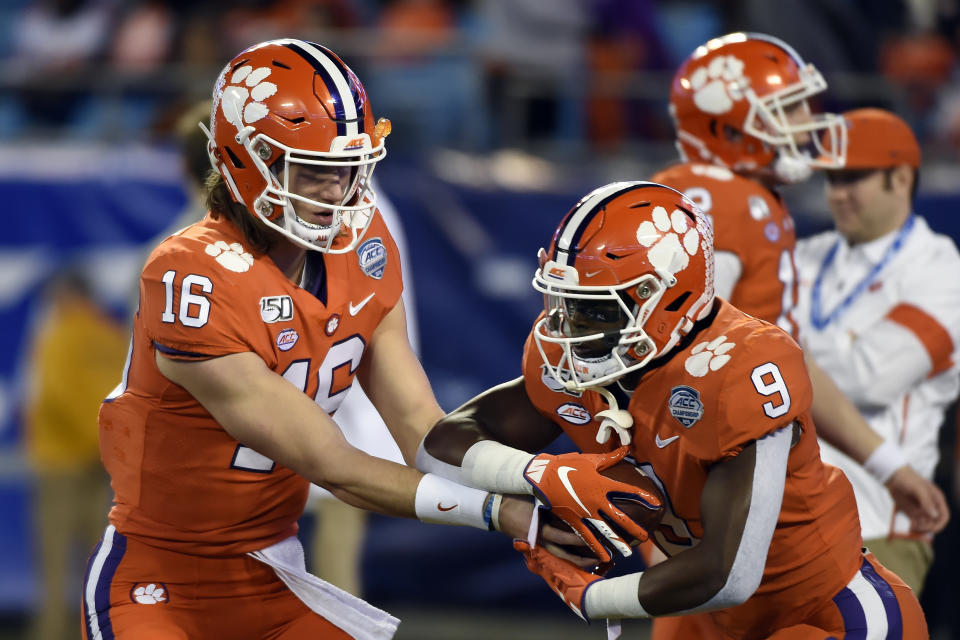 Clemson quarterback Trevor Lawrence (16) hands off to Clemson running back Travis Etienne (9) during warmups prior to the Atlantic Coast Conference championship NCAA college football game between against Virginia in Charlotte, N.C., Saturday, Dec. 7, 2019. (AP Photo/Mike McCarn)