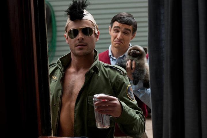 Zac Efron holds a beer in a Robert De Niro costume.