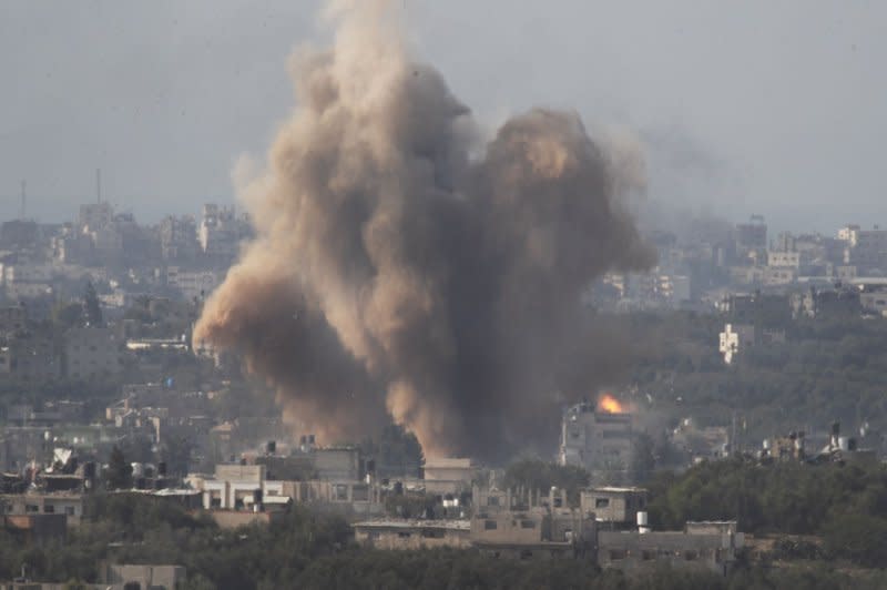 Israeli attacks an area inside the Gaza Strip as seen from a position inside southern Israel on Tuesday. Israeli forces continue to fight inside the Gaza Strip with ground forces, airstrikes and artillery strikes. A flash can be seen from the second bomb dropped. Photo by Jim Hollander/UPI