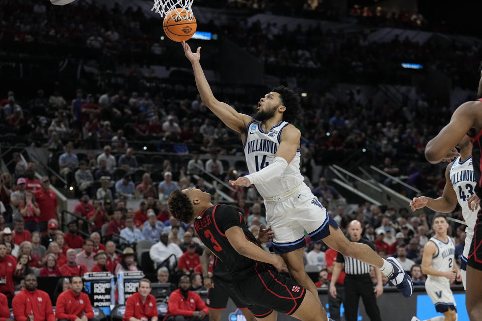 Villanova guard Caleb Daniels shoots over Houston guard Ramon Walker Jr. during the first half of a college basketball game in the Elite Eight round of the NCAA tournament on Saturday, March 26, 2022, in San Antonio. (AP Photo/Eric Gay)