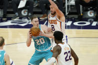 Charlotte Hornets forward Gordon Hayward (20) drives on Phoenix Suns forward Frank Kaminsky (8) during the first half of an NBA basketball game, Wednesday, Feb. 24, 2021, in Phoenix. (AP Photo/Matt York)