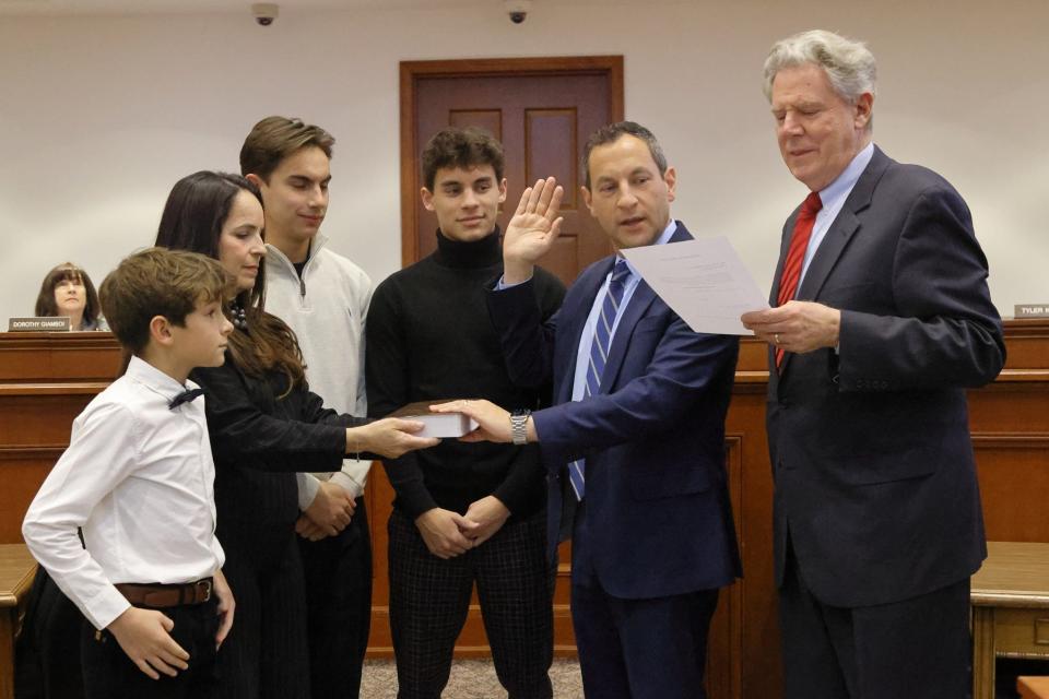 Metuchen Mayor Jonathan Busch was sworn into office by Rep. Frank Pallone Jr. for another term during Monday's reorganization meeting.