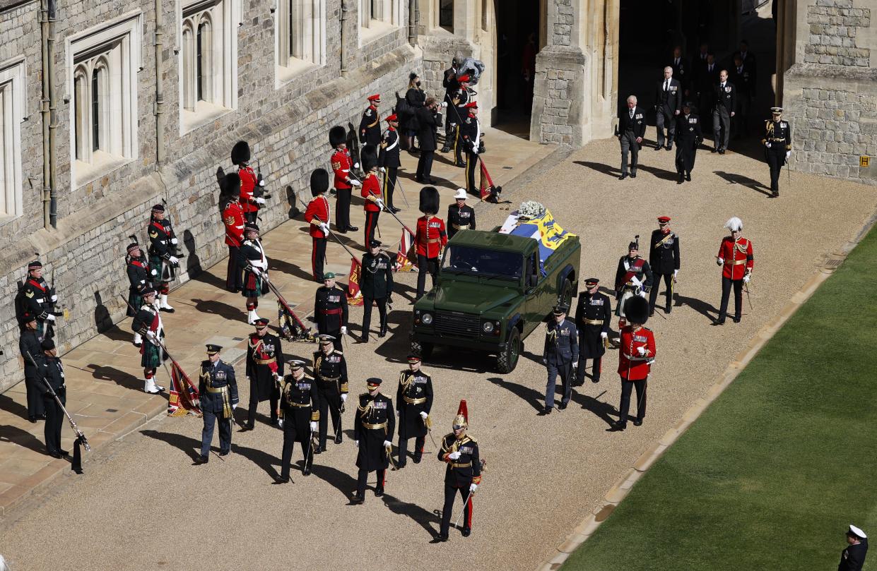 Members of the Royal family, led by Prince Charles, rear left, follow behind the coffin of Britain's Prince Philip in the Quadrangle at Windsor Castle in Windsor, England, Saturday, April 17, 2021.