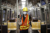 A contractor uses an electrostatic sprayer to disinfect subway cars at the 96th Street station to control the spread of COVID-19, Thursday, July 2, 2020, in New York. Mass transit systems around the world have taken unprecedented — and expensive — steps to curb the spread of the coronavirus, including shutting down New York subways overnight and testing powerful ultraviolet lamps to disinfect seats, poles and floors. (AP Photo/John Minchillo)