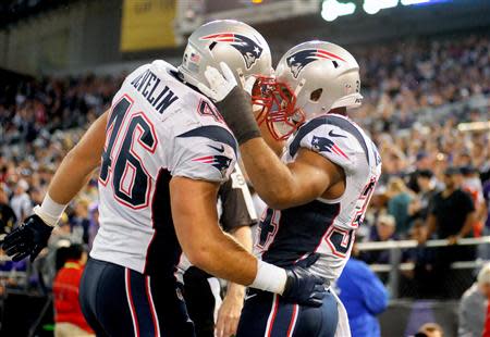 Dec 22, 2013; Baltimore, MD, USA; New England Patriots running back Shane Vereen (34) is congratulated by fullback James Devlin (46) after scoring a touchdown in the first quarter against the Baltimore Ravens at M&T Bank Stadium. Mandatory Credit: Evan Habeeb-USA TODAY Sports