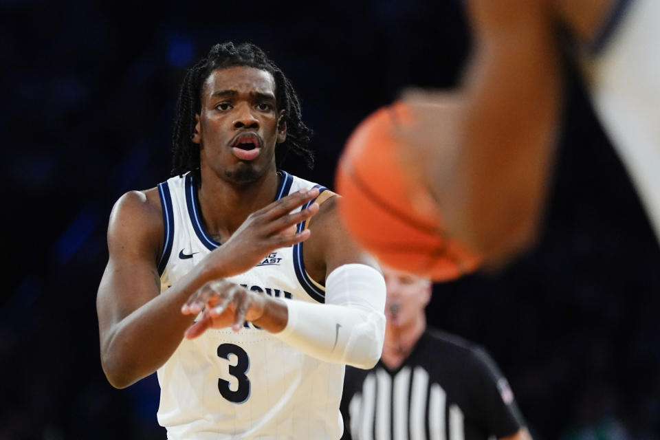 Villanova's Chris Arcidiacono (4) passes the ball to Jermaine Samuels during the first half of an NCAA college basketball game against Connecticut in the semifinals of the Big East men's tournament Friday, March 11, 2022, in New York. (AP Photo/Frank Franklin II)