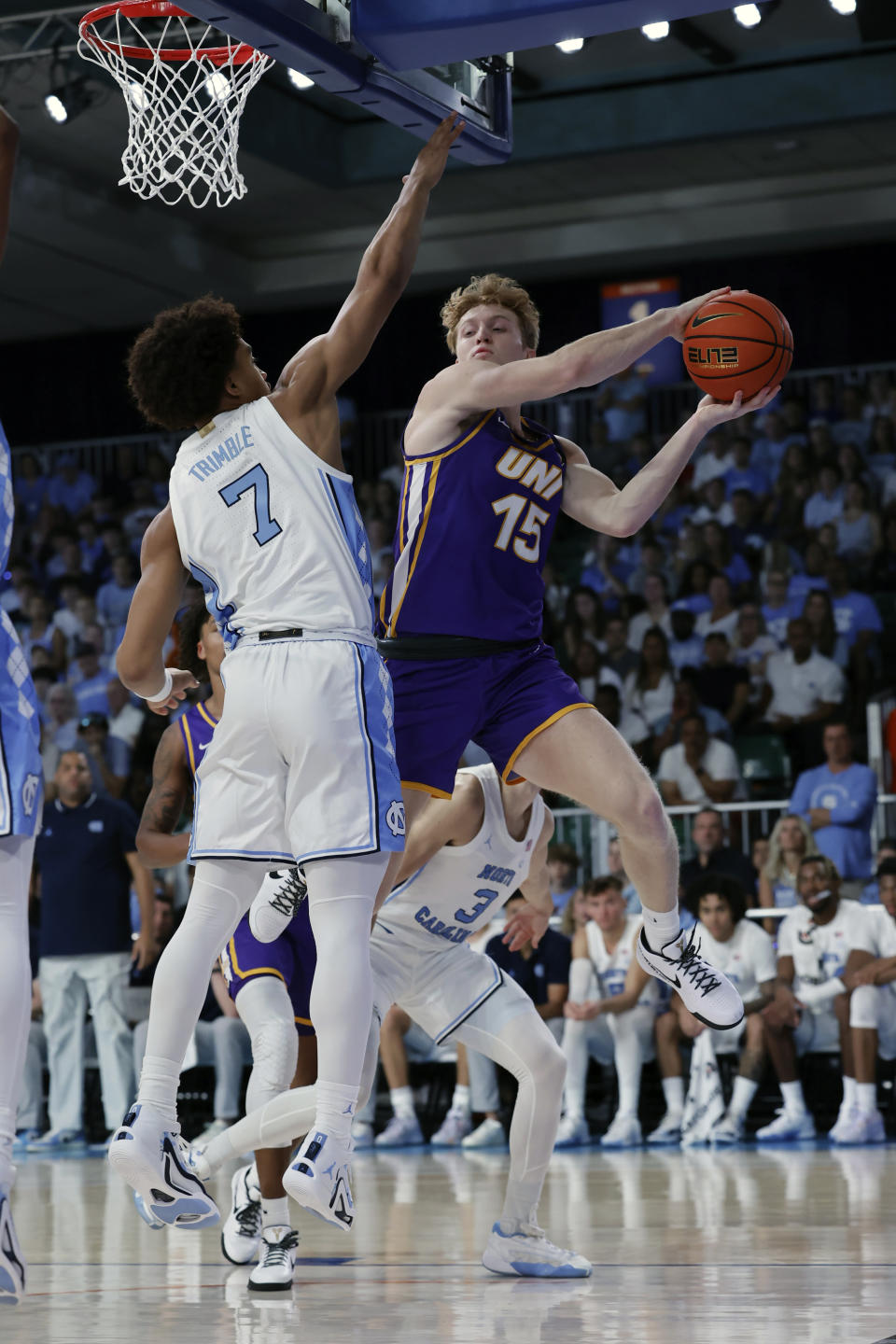 Northern Iowa's Michael Duax looks to pass the ball against North Carolina's Seth Trimble during the first half of an NCAA college basketball game in the Battle 4 Atlantis at Paradise Island, Bahamas, Wednesday, Nov. 22, 2023. (Tim Aylen/Bahamas Visual Services via AP)