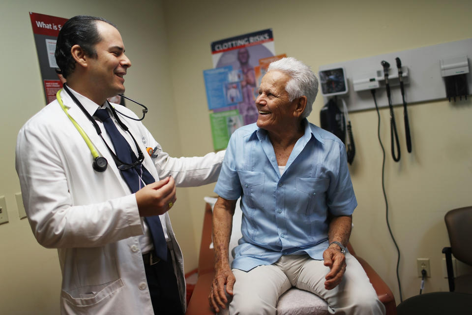 Ivan Mendoza, MD, associate medical director for the Jackson Medical Group's cardiology practice, (L) speaks with Felipe Finale, 78, during a media event at Jackson South Community Hospital to announce his successful implant of the world's smallest pacemaker.