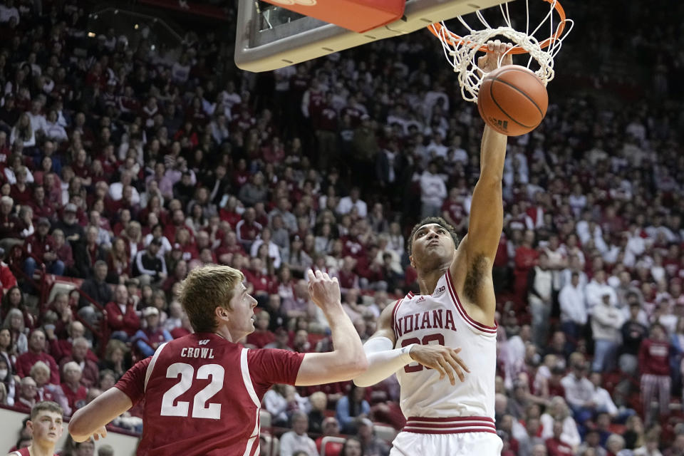 Indiana's Trayce Jackson-Davis (23) dunks over Wisconsin's Steven Crowl (22) during the second half of an NCAA college basketball game, Saturday, Jan. 14, 2023, in Bloomington, Ind. (AP Photo/Darron Cummings)